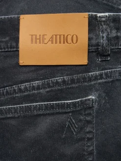 Jeans a gamba larga in tela spalmata