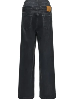 Jeans a gamba larga in tela spalmata
