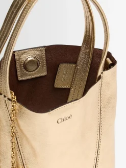 Spin metallic leather top handle bag